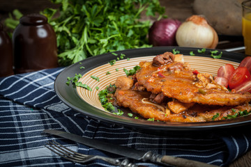 Potato pancakes with meat, vegetable, tomato and parsley.