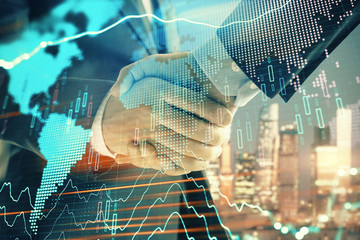 Double exposure of financial chart and world map on cityscape background with two businessmen handshake. Concept of international investment