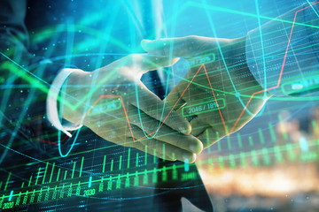 Obraz na płótnie Canvas Double exposure of financial chart on cityscape background with two businessmen handshake. Concept of financial analysis and investment opportunities