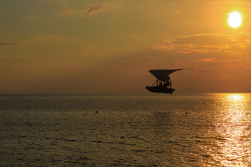 boat in the sky at sunset