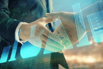Double exposure of chemistry theme hologram on city view background with handshake. Concept of education