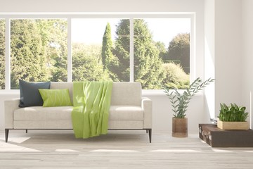 Stylish room in white color with sofa and summer landscape in window. Scandinavian interior design. 3D illustration