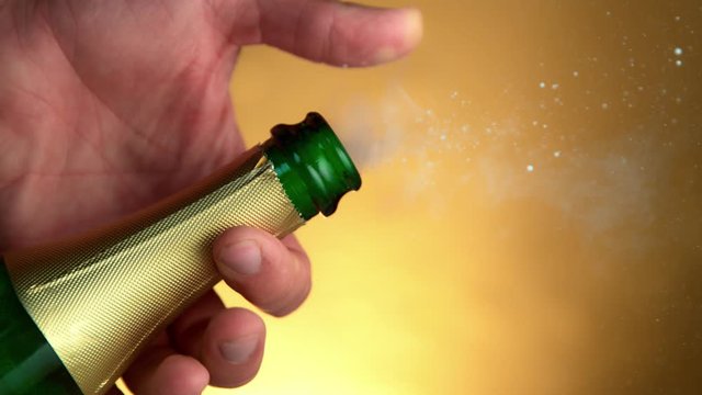 Super Slow Motion Shot of Champagne Explosion on Golden Luxury Background at 1000fps.