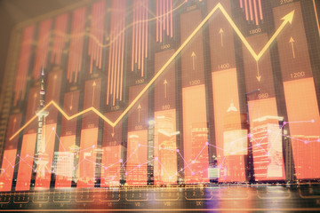 Financial graph on night city scape with tall buildings background double exposure. Analysis concept.