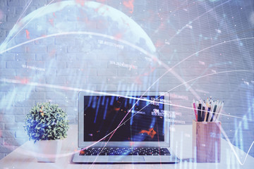 Financial graph colorful drawing and table with computer on background. Double exposure. Concept of international markets.