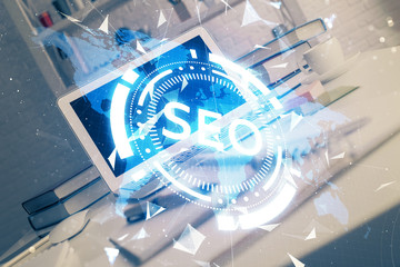 Multi exposure of table with computer and seo drawing hologram. Search optimization concept.