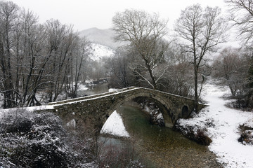 View of the traditional stone Bridge of Kamber Agas in Epirus, Greece in winter