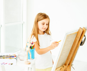 girl makes pencil sketch on canvas