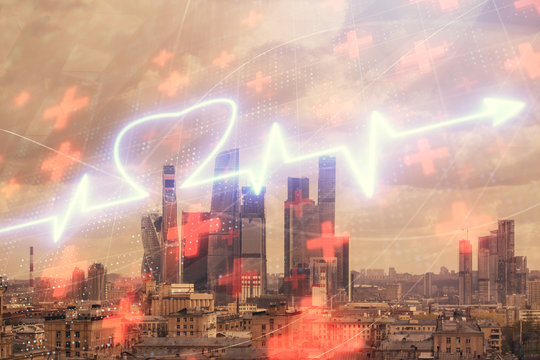 Multi exposure of human heart hologram on Moscow cityscape background. Concept of medical education