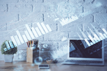 Financial chart drawing and table with computer on background. Double exposure. Concept of international markets.