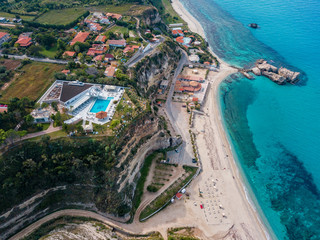 Aerial view of the Calabrian coast, cliffs overlooking the crystal clear sea and luxury villas....