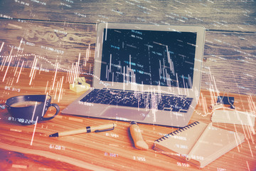 Double exposure of graph and financial info and work space with computer background. Concept of...
