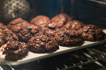 chocolate muffins baking in a modern oven