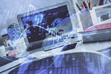 Financial market graph hologram and personal computer on background. Multi exposure. Concept of forex.