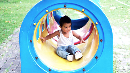 Asian Children 2 year old playing in the garden outdoor holiday kid concept.