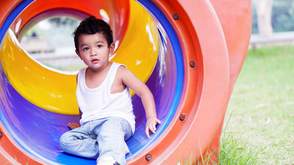 Asian Children 2 year old playing in the garden outdoor holiday kid concept.