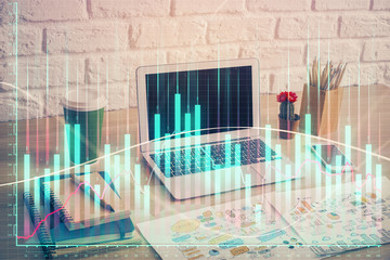 Financial graph colorful drawing and table with computer on background. Double exposure. Concept of international markets.
