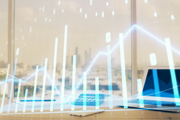 Forex graph hologram on table with computer background. Multi exposure. Concept of financial markets.