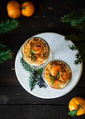 Citrus trifle with fresh tangerines. Christmas portioned dessert on the festive table.