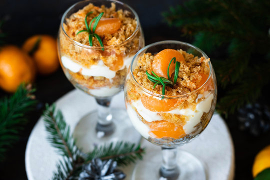 Citrus trifle with fresh tangerines. Christmas portioned dessert on the festive table.