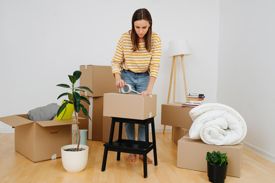 Woman Packing, She's Moving Out From Old Apartment To A New One.