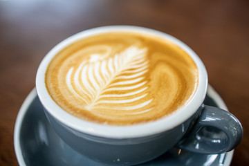 cup of coffee with cream on white background