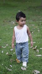 Asian Children 2 year old playing in the garden outdoor holiday kid concept.