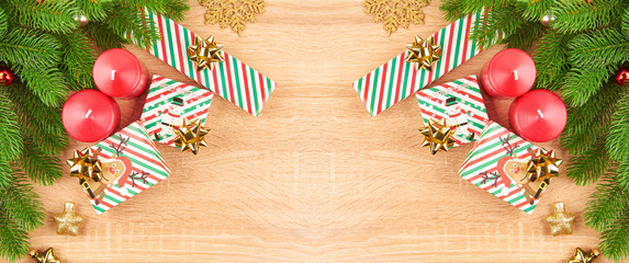 Christmas background with fir branches, various Christmas decorations, colored garlands and beads, on a light wood background. Christmas decorations. Christmas background. Space for text.