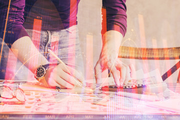 Multi exposure of man standing and planing investment with stock market forex chart.