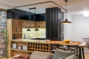 Kitchen and dining area in open plan apartment interior - obrazy, fototapety, plakaty