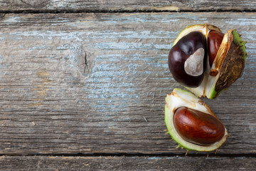 Still life of chestnuts on arustic wood table.