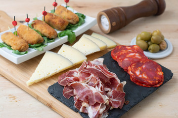  Typical Spanish food consisting of croquettes, Manchego cheese, chorizo ​​and olives