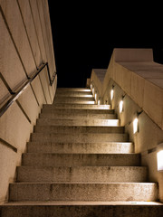 stairs with illuminated steel railing with geometric shapes