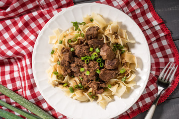 Stewed beef with tagliatelle pasta.