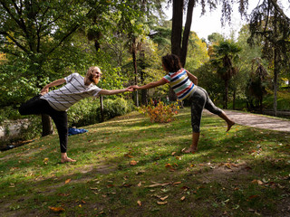  nomadic travelers practicing yoga in the park