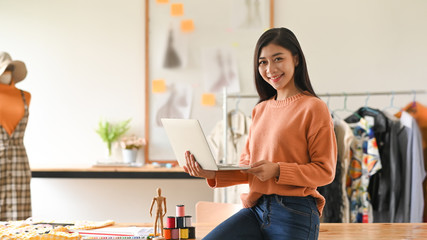 Portrait of fashion designer standing front of her studio.