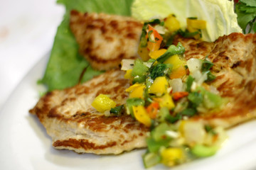 grilled chicken file with fresh vegetable salad, selective focus