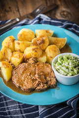 Braised meat in sauce served with boiled potatoes.