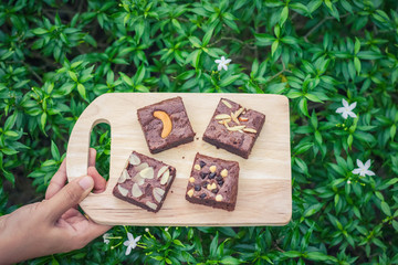 Fudge brownies on wooden plate and top view