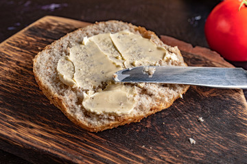 Slice of bread smeared with butter.
