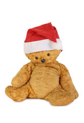 Teddy bear in a Christmas hat on white background