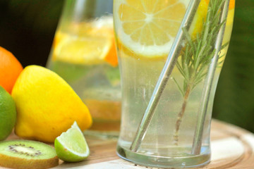 Close up preparing ice cocktail lemonade at hot summer day. Metal straw. Eco friendly picnic on  meadow.  Reusable 