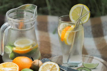 Close up preparing ice cocktail lemonade at hot summer day. Metal straw. Eco friendly picnic on  meadow.  Reusable 