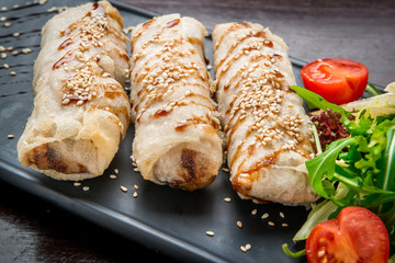 Homemade hot dog wraps in pita on black background