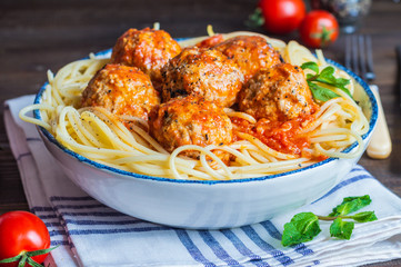 meatball in fresh tomato sauce on a bed of freshly cooked spaghetti