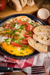 Homemade breakfast fried egg with tomato.