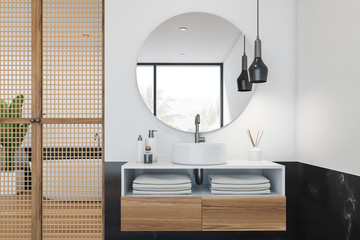 Black marble and white bathroom, tub and sink