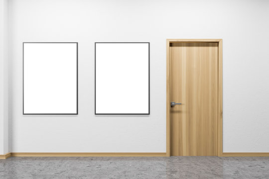 Empty white room interior with posters and door