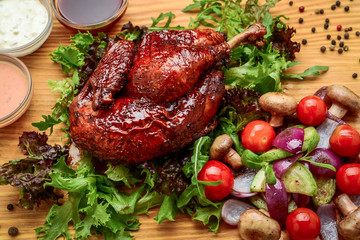 Grilled chicken Tabaka with sauce on stone plate.