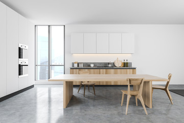 White kitchen with wooden dining table